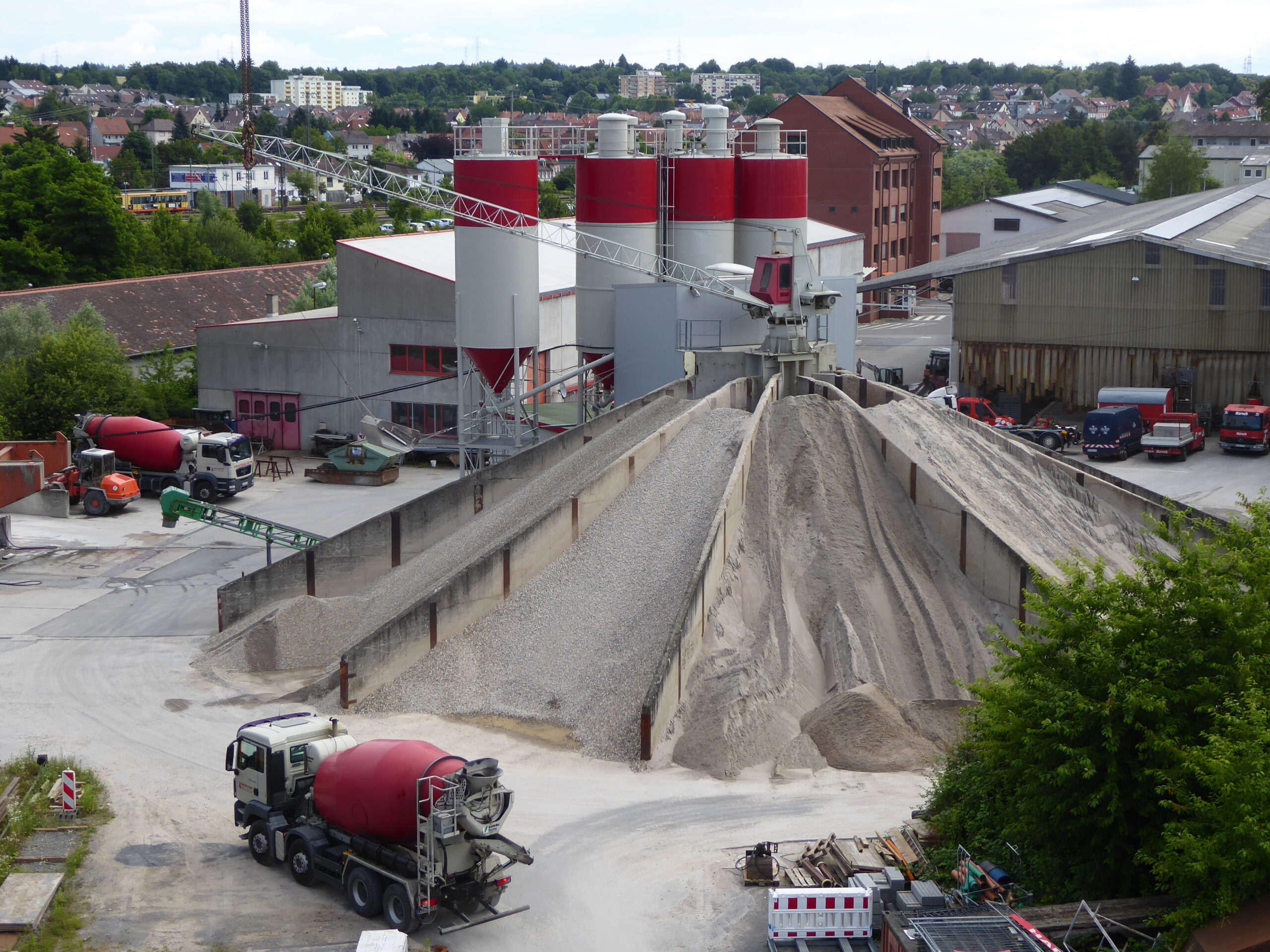 Transportbetonwerk mit Siloanlagen, Zuschlagstoffhalden und Betonmischfahrzeugen.